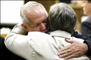 Plaintiff Frederick "Mike" Humeston and his wife hug Thursday after Merck & Co. won a ruling in the battle over its Vioxx painkiller. The ruling means Merck won&squot;t be held liable for the 2001 heart attack suffered by Humeston while taking Vioxx.