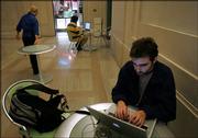 Massachusetts Institute of Technology graduate student Jose Expinosa, of Mexico City, works on his computer Thursday while connected to the school's wireless Internet in Cambridge, Mass. The school's newly upgraded wireless network covers the entire 9.4 million-square-foot campus.