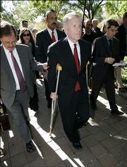 I. Lewis 'Scooter' Libby, Vice President Dick Cheney's former chief of staff, center, leaves the U.S. District Court, with lawyers William Jeffress, left, and Ted Wells, back center, Thursday in Washington. Libby pleaded not guilty Thursday in the CIA leak scandal.
