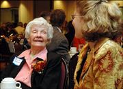 Tensie Oldfather, left, talks with her daughter-in-law, Dyann Myers, of Stillwater, Minn., on Thursday during the Bert Nash fundraiser "An Evening with Tensie Oldfather and Friends" at the Lawrence Holidome.