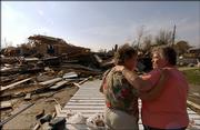 Dorothy Barnett, 72, left, from DeGonia Springs, Ind., is consoled by her sister, Sandra Sickbert, 68, as they look over the remains of the Baker Chapel United Methodist church outside of DeGonia Springs. It was destroyed by a tornado.