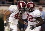 Alabama linebacker Juwan Simpson, left, and defensive end Wallace Gilberry celebrate a fourth-quarter interception against Mississippi State. 'Bama remained unbeaten with a 17-0 victory on Saturday in Starkville, Miss., and Monday moved up to No. 3 in the BCS standings.