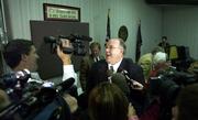 Members of the local, national and international press converge around Board of Education chairman Dr. Steve Abrams as he expresses his happiness about the board's successful vote on adopting the new science standards. Abrams voted in favor of the measure, which passed 6-4.