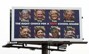 A billboard with the opponents to the current Dover Area School Board is seen Tuesday above Main Street in Dover, Pa. Voters swept out the conservative members of the board.