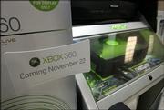 A sign promoting the November release of XBox 360, the newest version of Microsoft Corp.'s video-gaming console, is shown on display next to the current version of the gaming system Oct. 26 at a CompUSA store in Bellevue, Wash.