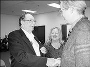 Richard Fraser, left, receives congratulations from John Naughton, grand master with District 12, for serving 25 years as a Mason by Lawrence Lodge No. 6. Fraser's wife, Shirley, looks on. He was recognized during a ceremony Oct. 10.