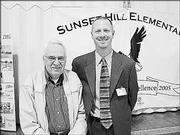 Calvin Rice, left, retired principal of Sunset Hill School, poses with the current principal, Chris Bay, during the school's 50th anniversary celebration. The school celebrated the milestone Oct. 6.