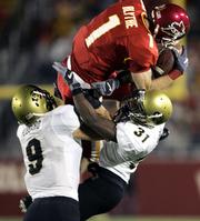 Iowa State's Todd Blythe makes a reception over Colorado's Gerett Burl (31) and Tom Hubbard (9). The Cyclones beat the Buffaloes, 30-16, Saturday night in Ames, Iowa.