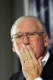 Kansas State football coach Bill Snyder blows a kiss to his family as he announces his retirement during a news conference. Snyder, 66, retired from a Wildcat program he coached from college football's depths. He announced Tuesday in Manhattan he would step down after this season.