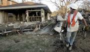 Robert Newsom removes debris from a house that was damaged by floodwaters in New Orleans. While many homes are still uninhabitable, FEMA is warning evacuees still living in hotels that they have until Dec. 1 to find other housing.