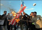 Iranian students burn a U.S. flag during a demonstration to support Iran's nuclear program Friday in front of the Natanz Uranium Enrichment Facility, some 200 miles south of the capital, Tehran, Iran.