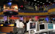 Media representatives look around Al-Jazeera's new news room in Doha, Qatar, in this June 15 file photo. The Daily Mirror reported Tuesday that a government memo suggested that Prime Minister Tony Blair persuaded President Bush not to bomb the Arab satellite station Al-Jazeera.