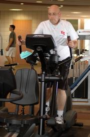 After: This photo shows the lighter, fitter Anguiano working out Tuesday at KU's Student Recreation Center.