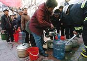 Chinese residents line up Wednesday to receive water from fire trucks in Harbin. The Chinese city of 3.8 million people closed schools and was trucking in drinking water after shutting down its water system after a chemical plant explosion that officials said polluted a nearby river with toxic benzene.
