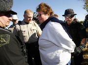 Dede Miller, sister of Cindy Sheehan, is arrested by McLennan County Sheriff's deputies Wednesday for camping in a county ditch in Crawford, Texas. A dozen war protesters, including a Lawrence woman, were arrested Wednesday on trespassing charges.