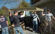 Pi Kappa Phi fraternity members at Kansas University help construct a house ramp for an elderly Lawrence resident earlier this month. Greek organization members say they do many public service activities, but their reputations are harmed by hazing and partying allegations.