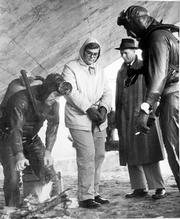 Lowell Lee Andrews, center, stands as officers and divers search the Kansas River for parts of guns Andrews used to kill his parents and sister on Nov. 27, 1958. Andrews, then a mild-mannered, 18-year-old Kansas University sophomore, was one of the last criminals to be executed in Kansas.