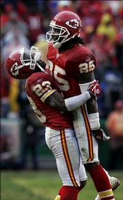Kansas City Chiefs cornerback Patrick Surtain (23) celebrates with safety Greg Wesley (25) after Wesley pulled down his third interception of the game during the fourth quarter of the Chiefs' 26-16 victory over New England. K.C. beat the Patriots Sunday at Arrowhead Stadium in Kansas City, Mo.