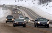 Cars travel over Vail Pass during a lingering winter storm in the Colorado mountains in this 2005 photo near Vail, Colo.