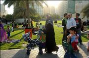 Families evacuate from high-rise buildings to Al Majaz Park in Sharjah, United Arab Emirates, after an earthquake in Iran shook buildings there.