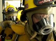 Lawrence-Douglas County Fire & Medical firefighter Rod Sumonja, front, undergoes an exercise in rescue breathing with fellow firefighter Rich Young during training Wednesday at Station 3. Fire & Medical is among several city and county departments to merge; some state officials, including Gov. Kathleen Sebelius, are pushing for more government consolidation.