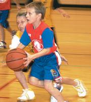Terrapin Joel Spain works the corner as he gets to the basket Nov. 30 against the Yellow Jackets. The Terrapins continued their winning streak dating bak to the Hoopster preseason tournament by defeating the Yellow Jackets 40-6 in the second- and third-grade game.