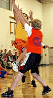 Yellow Jacket Tye Hughes, back, goes up for the shot against Gator defender Cody Stanclift in the fourth quarter Nov. 29 at Langston Hughes Elementary. The Gators withstood the Yellow Jacket comeback to win 33-14.
