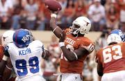 Texas quarterback Vince Young, right, unleashes a pass in the first half of the Longhorns' 66-14 victory over Kansas University. UT beat the Jayhawks on Nov. 12 in Austin, Texas.