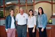 Lawrence radio personality Hank Booth, second from left, poses with Central National Bank employees, from left, Amanda Vail, Adele Bisel and Jen Haase after the Small Business Phon-a-thon Oct. 13. KLWN/KLZR radio sponsored a United Way Day on the radio to encourage gifts for the small business division of the United Way campaign.