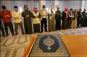 Ehab Lotayef, an envoy of the Canadian Islamic Congress, fifth from left, gives Friday Muslim prayers at the al-Imam al-Aadam mosque in a predominantly Sunni Arab neighborhood in Baghdad.