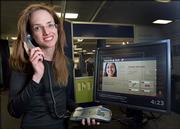 Margaret Morris, senior researcher for Intel, demonstrates a phone with a visual caller ID system Dec. 11 during the White House Conference on Aging.