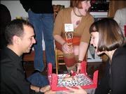 Kansas University alumna Julianne Donovan, center, invites guests to thumb wrestle at her annual Festivus party. The less-dangerous
ritual takes the place of actual wrestling, which was a component of the Festivus celebration made popular in a 1997 "Seinfeld" episode.