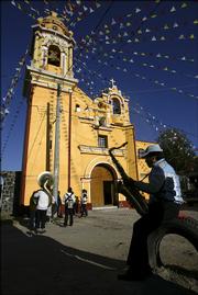 A band waits in front of the church of San Diego during a religious festival. Cholula has more religious festivals every year - about 400 - than any other town in Mexico.