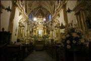 People pray at the church of San Gabriel in Cholula, Mexico. Cholula has several dozen elaborately decorated churches.