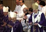 Cardinal Camillo Ruini, auxiliary bishop of Rome, third from left, smiles as Pope Benedict XVI, right, greets the faithful in Santa Maria Consolatrice Church during his first visit as pontiff to a parish church in Rome. The pope used Sunday's service to talk about the true meaning of Christmas.