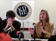 Dr. Howard Rodenberg, left, Kansas state health director, listens as Gail R. Hansen, Kansas state epidemiologist, speaks Wednesday about whooping cough during a news conference in Topeka.