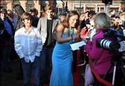 Actress Q&squot;Orianka Kilcher, center, who plays Pocahontas in the movie, "The New World," signs an autograph before the East Coast debut of the film Wednesday in Williamsburg, Va.