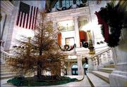 An 18-foot Colorado Blue Spruce Christmas tree stands brown and stripped of its needles Wednesday in the Rotunda of the Rhode Island Statehouse in Providence.
