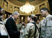 U.S. Secretary of Defense Donald H. Rumsfeld, left, meets troops at the Al Faw Palace in Baghdad, Iraq. Rumsfeld arrived unannounced Thursday in Baghdad to hold talks with U.S. commanders and assess the next phase of U.S. troop deployments in Iraq.