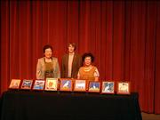 Celia Smith, right, stands with the awards she created for the 10th annual Phoenix Awards ceremony Nov. 6. Eight of her original paintings, all depicting legends of the phoenix, were presented to the winners. The painting, at center, is on display outside the city manager's office in City Hall. At left is Sue Kwak, who received the Educator in the Arts Award. Karen Lacchio, Topeka, center, nominated Kwak at the ceremony in place of Sarah Kwak who had nominated her mother but was unable to attend.