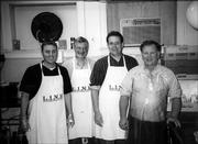 Members of the Lawrence Kiwanis Club, from left, Jason Novotny, Mike McDonald, Dan Gaumer and Jim Kearney, help with cleanup duties at Lawrence Interdenominational Nutrition Kitchen on Nov. 22. The club provided and served the meal.