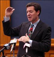 U.S. Sen. Sam Brownback, R-Kan., speaks to reporters Friday at the Kansas Statehouse in Topeka. Brownback discussed a variety of current political issues, including wiretap surveillance of U.S. citizens and his own prospects for running for president.