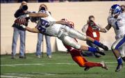 Kansas university defensive end charlton keith dives into the end zone for a touchdown after he intercepted a pass against Houston in the Fort Worth Bowl. Keith, who likely will be taken in this year's NFL Draft, in 2005 helped anchor a Jayhawk defense that can be compared to KU's best-ever units.