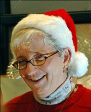 Elaine Skoch, Eudora, serves food at the community Christmas dinner at First United Methodist Church in Lawrence. It was Skoch&squot;s first time to volunteer at the annual meal. "I&squot;ve had a ball," she said.