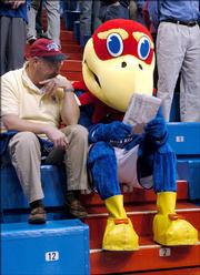 Ed Lanning, Overland Park, lets Big Jay read his newspaper before tipoff of last Saturday's men's basketball game against Kentucky in Allen Fieldhouse. KU defeated the ranked Wildcats 73-46. Today, KU plays rival Kansas State University at home.
