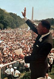 The Rev. Martin Luther King Jr. acknowledges the crowd at the Lincoln Memorial for his "I Have a Dream" speech during the March on Washington, D.C., in this Aug. 28, 1963, file photo. The march was organized to support proposed civil rights legislation and end segregation.