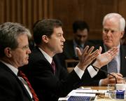 Sen. Sam Brownback, R-Kan., center, offers his reasons to confirm Supreme Court nominee Samuel Alito as the Senate Judiciary Committee deliberates on Tuesday. Brownback is flanked by Sen. Tom Coburn, R-Okla., left, and Sen. John Cornyn, R-Texas. With all 10 Republicans voting for Alito and all eight Democrats voting against him, President Bush's pick to replace Associate Justice Sandra Day O'Connor will now advance to the full Senate for the final vote.