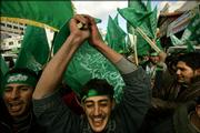 Palestinian supporters of Hamas celebrate their victory in parliamentary elections in the West Bank town of Ramallah, Thursday, Jan. 26, 2006. Hamas supporters briefly raised their flag over the Palestinian parliament and rushed into the building, amid clashes with Fatah loyalists. The two camps threw stones at each other, breaking windows in the building, as Fatah supporters briefly tried to lower the green Hamas banners. It was the first confrontation between Hamas and Fatah since the Islamic militant group won parliament elections on Wednesday.