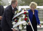 William Gerstenmaier, associate administrator for Space Operations at NASA, and June Scobee Rodgers, widow of Dick Scobee, Challenger's commander, place a wreath at the base of the Space Mirror Memorial on Saturday during a ceremony for the Challenger astronauts at the Kennedy Space Center.
