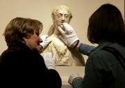 Docent Carolyn Reintjes, left, talks to Tina Jinkens as she feels a 15th-century marble bust of St. John the Baptist during a tour for blind persons at the Nelson-Atkins Museum of Art in Kansas City, Mo. The new touch tour is among programs at more than 100 museums nationwide.
